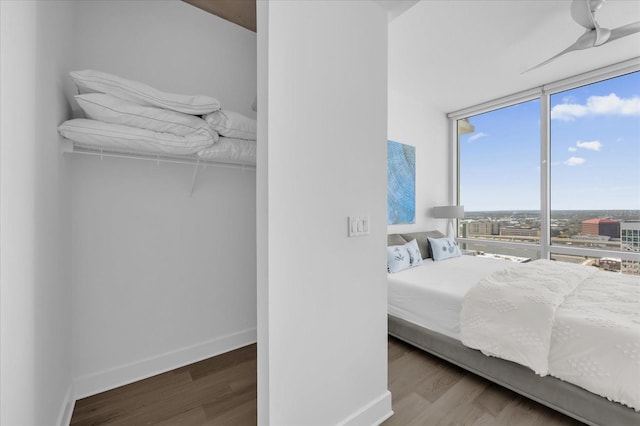 bedroom with wood-type flooring and floor to ceiling windows