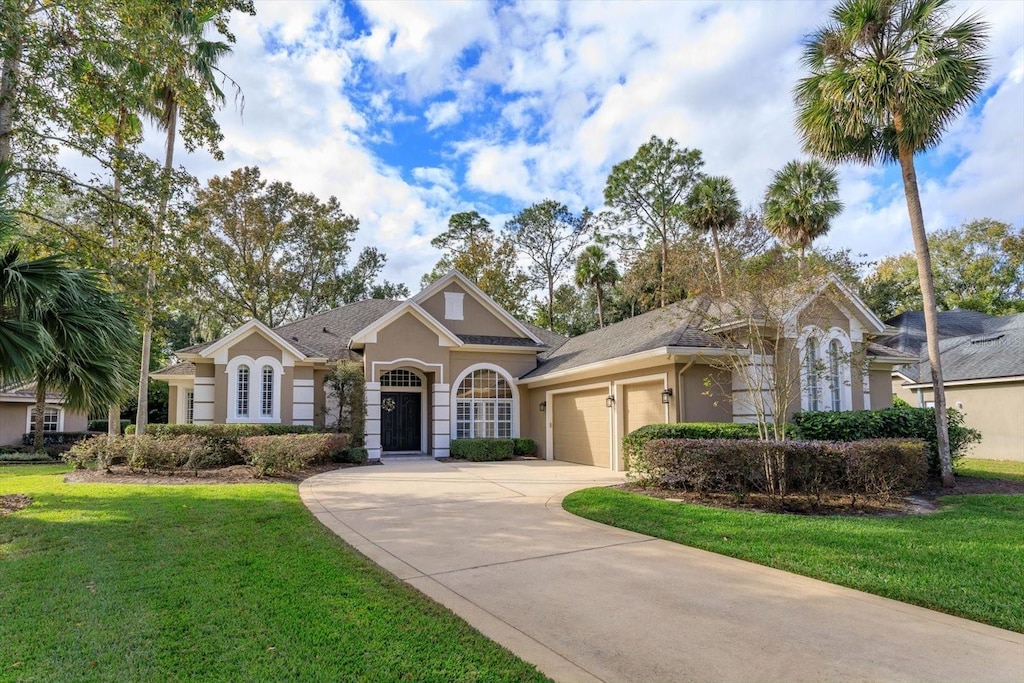 view of front of house featuring a front lawn and a garage