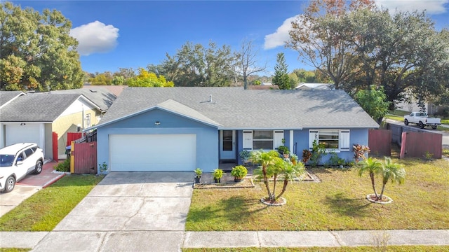 ranch-style house with a garage and a front lawn