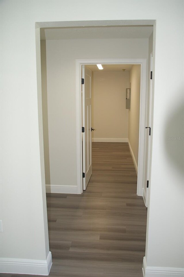 hallway with dark hardwood / wood-style flooring