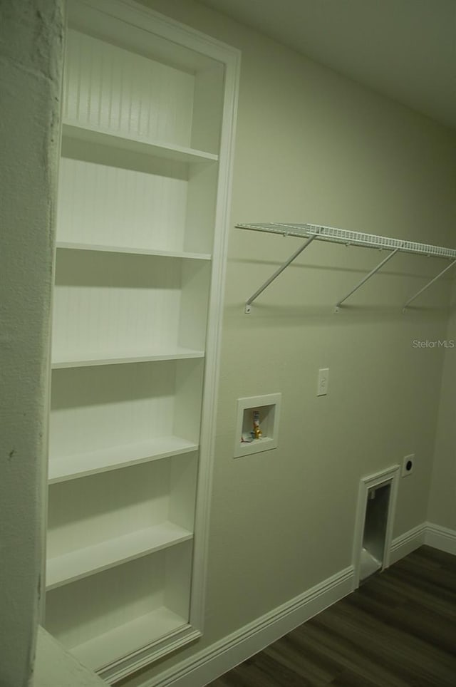 clothes washing area featuring electric dryer hookup, washer hookup, and dark hardwood / wood-style floors