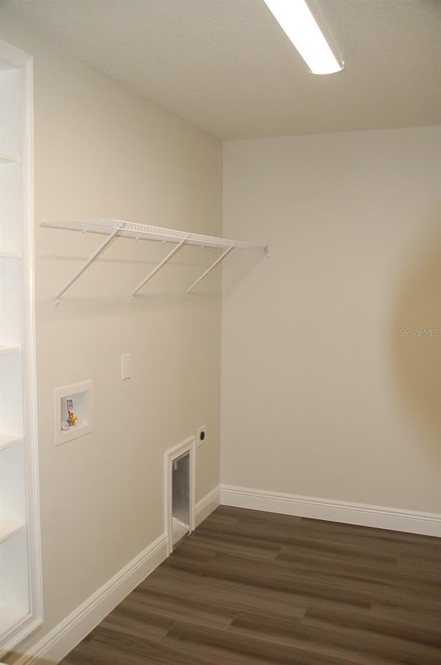 laundry area with hookup for a washing machine, electric dryer hookup, and dark wood-type flooring