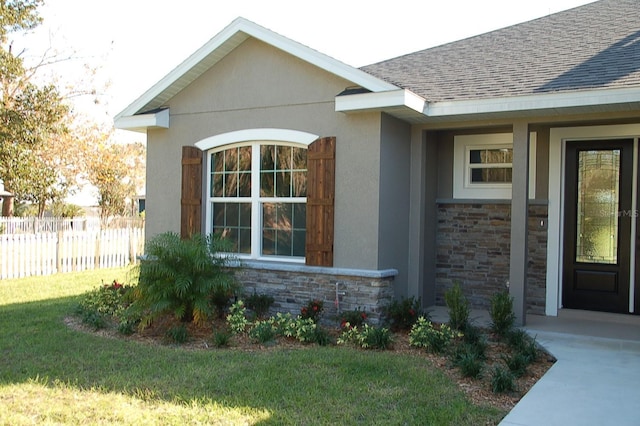 doorway to property with a yard