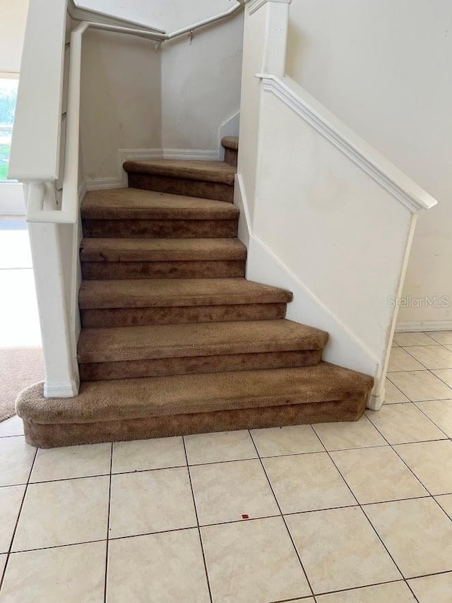 stairway with tile patterned flooring