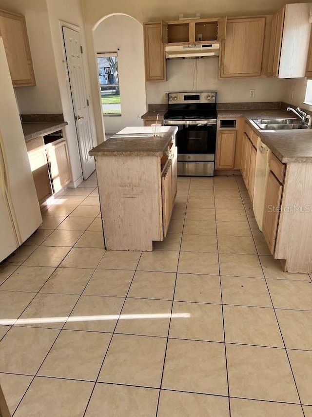 kitchen with sink, a center island, white appliances, light brown cabinetry, and light tile patterned floors