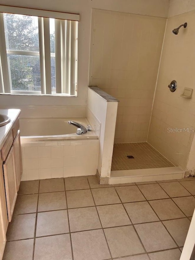 bathroom with separate shower and tub, tile patterned floors, and vanity