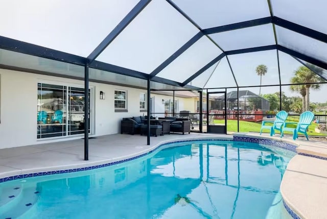 view of swimming pool featuring an outdoor living space, glass enclosure, and a patio