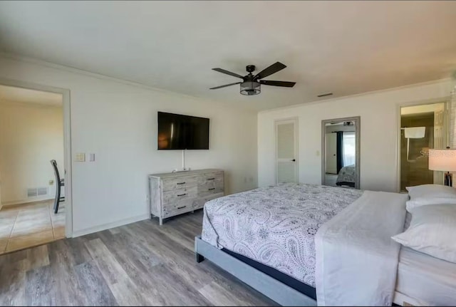 bedroom featuring hardwood / wood-style floors, connected bathroom, ceiling fan, and crown molding