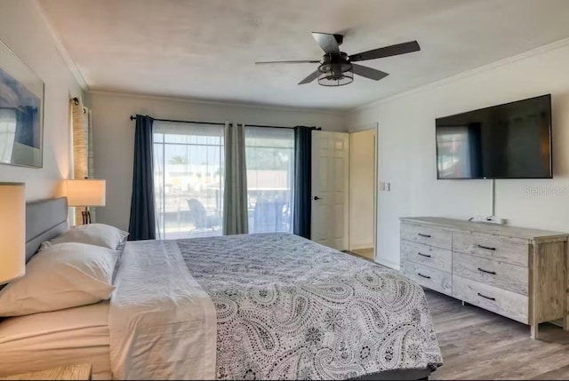 bedroom featuring wood-type flooring, ceiling fan, and crown molding