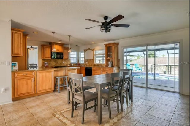 dining space with ceiling fan and light tile patterned floors