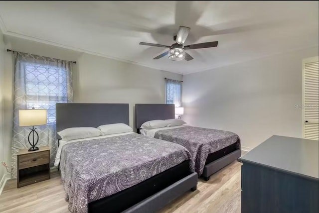 bedroom with ceiling fan and light wood-type flooring