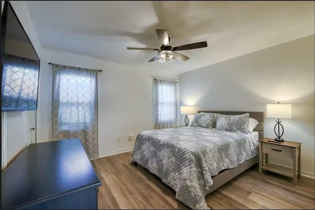 bedroom with hardwood / wood-style floors and ceiling fan