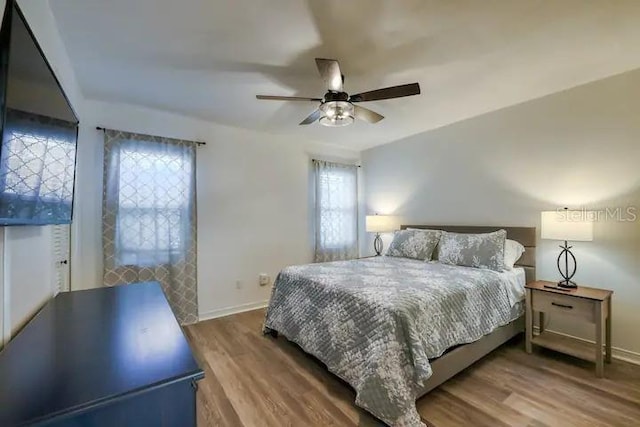 bedroom with ceiling fan and wood-type flooring