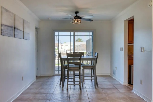 dining area with ceiling fan and ornamental molding