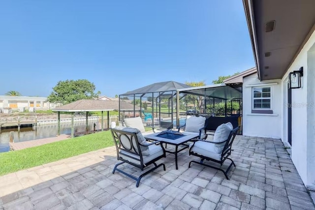 view of patio / terrace with a lanai and a water view