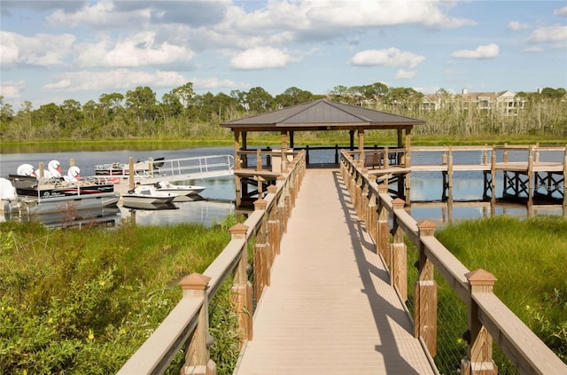 view of dock featuring a gazebo and a water view