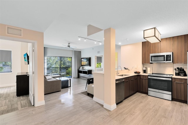 kitchen featuring a sink, modern cabinets, visible vents, and stainless steel appliances