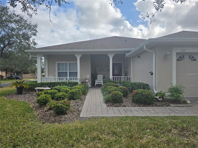 view of front of house with a porch and a garage