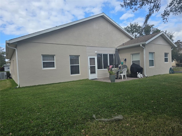 back of property featuring a patio area and a yard