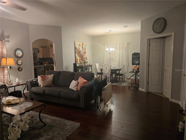 living room with dark hardwood / wood-style floors and a chandelier