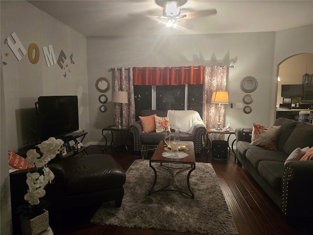 living room with ceiling fan and dark hardwood / wood-style flooring