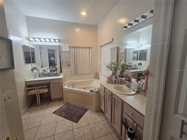 bathroom with tile patterned flooring, a bathtub, and vanity