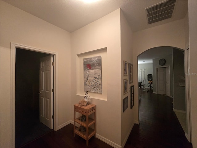 corridor with dark hardwood / wood-style flooring