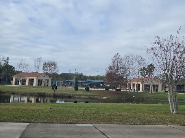 view of home's community featuring a yard and a water view