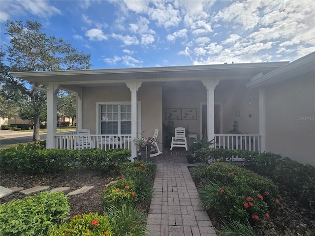 property entrance featuring covered porch