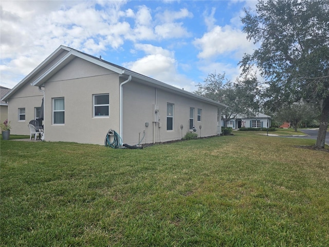 view of side of home with a lawn