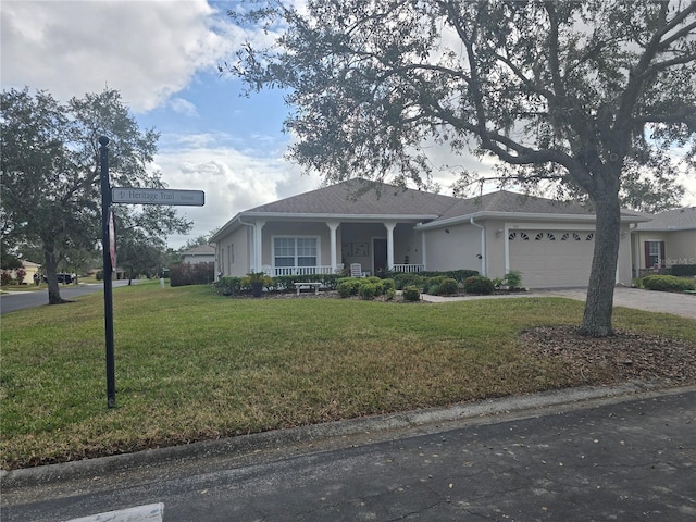 view of front facade featuring a front yard, a porch, and a garage