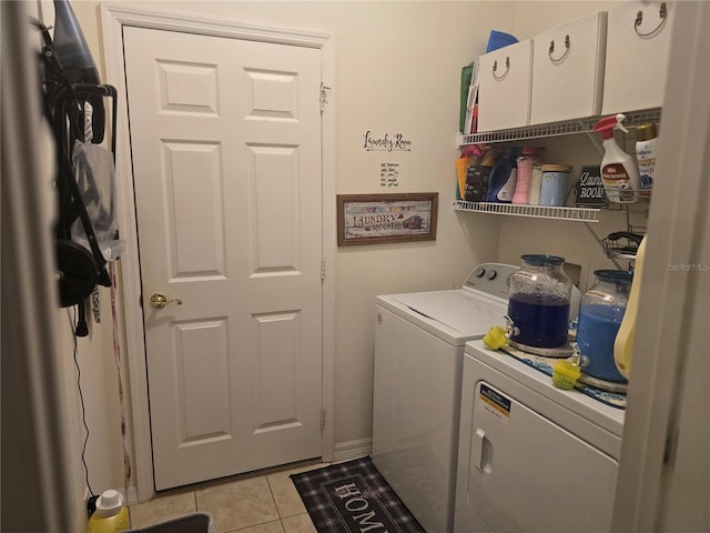 laundry room with light tile patterned floors and washing machine and dryer