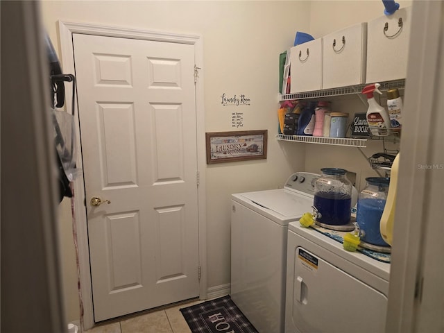 laundry room with light tile patterned floors and washing machine and clothes dryer