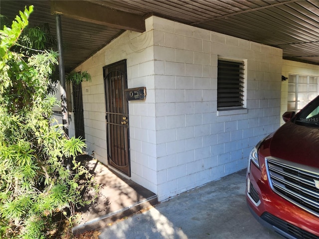 view of exterior entry with a carport