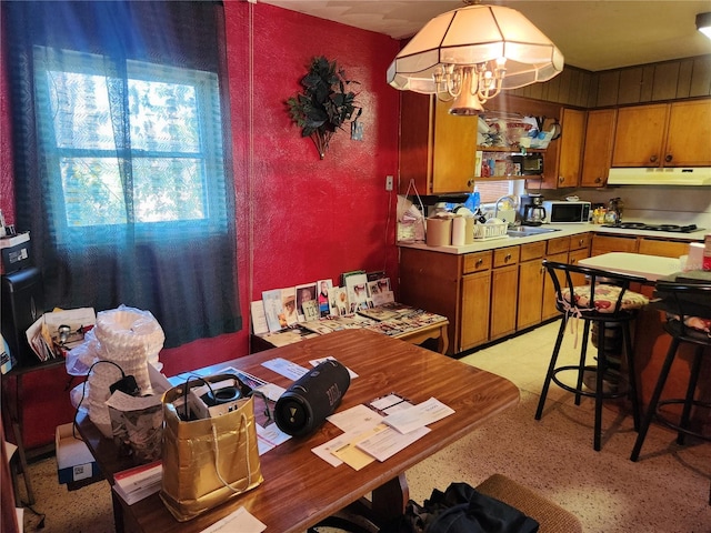 dining space with a notable chandelier and sink