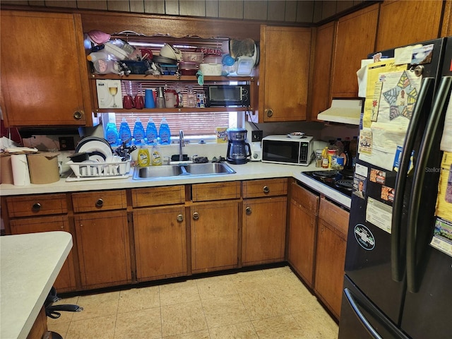 kitchen with sink, extractor fan, fridge, and black electric stovetop