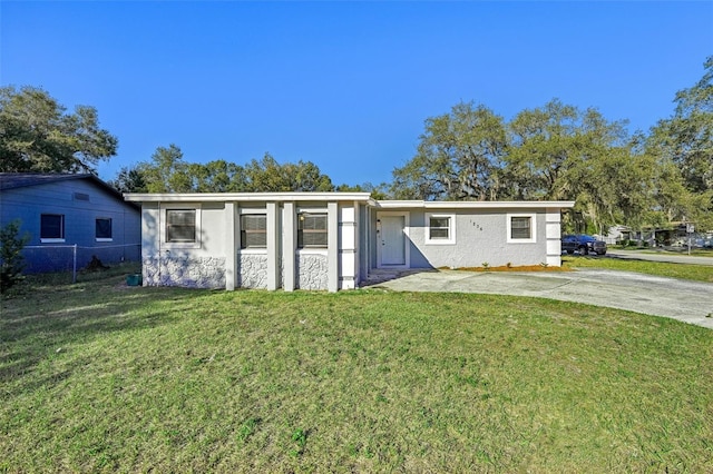 ranch-style house with a front lawn