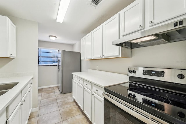 kitchen featuring light tile patterned flooring, appliances with stainless steel finishes, white cabinets, and sink