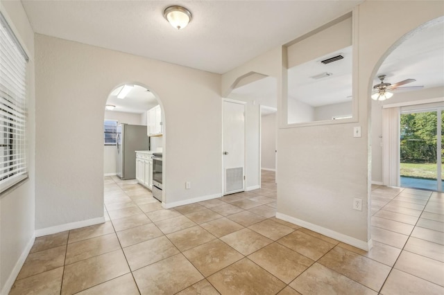 unfurnished room featuring ceiling fan and light tile patterned floors