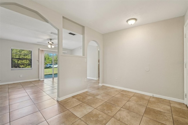 tiled empty room with ceiling fan