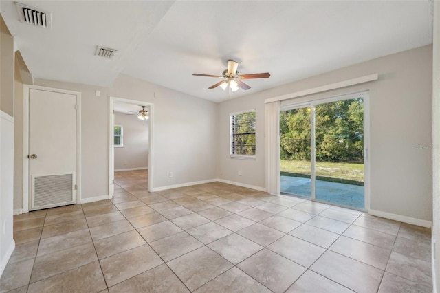 tiled spare room featuring ceiling fan