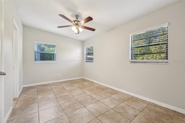 unfurnished room with ceiling fan and light tile patterned floors