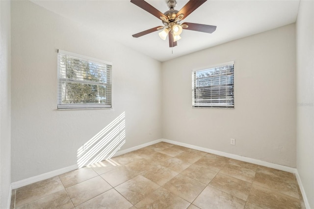 empty room featuring ceiling fan and light tile patterned flooring