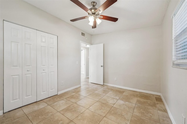 unfurnished bedroom featuring ceiling fan and a closet