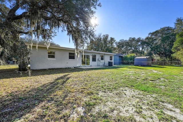 rear view of property featuring a lawn