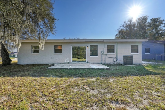 rear view of house with a patio area, a yard, and central air condition unit