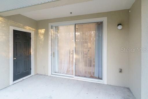 doorway to property with a patio