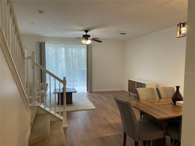 dining room with wood-type flooring and ceiling fan