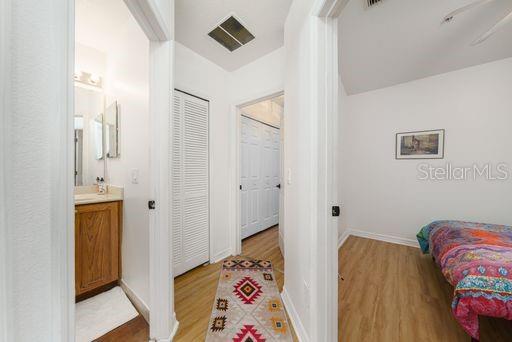 interior space with vanity and wood-type flooring