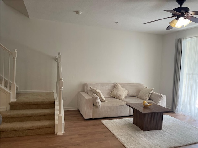 unfurnished living room with wood-type flooring and ceiling fan